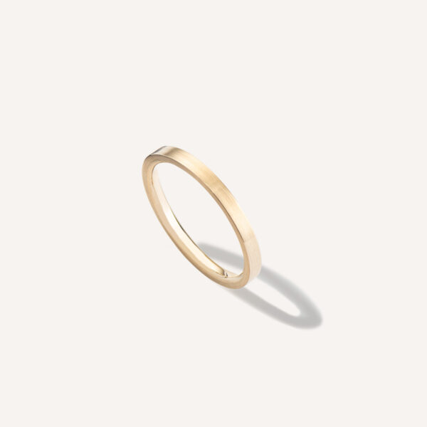 aliança de casamento feita à mão em ouro 18k e minimalista sobre fundo branco